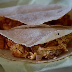 a close up of a chicken taco