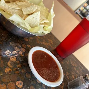 a bowl of chips and a bowl of salsa