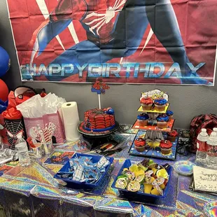 Birthday party set up with cake and cupcakes