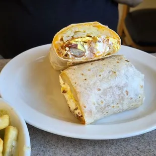Alex&apos;s burrito. Ham bacon sausage egg and has browns