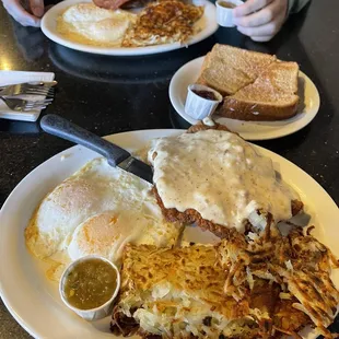 Country friend steak and eggs, wheat toast, and large breakfast- bacon, two over easy eggs, and hashbrowns.