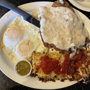 Country fried steak and gravy.  Over easy eggs.  And hash browns with home made salsa.