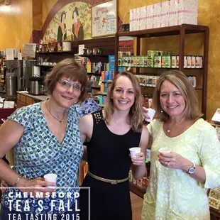 three women holding cups of tea