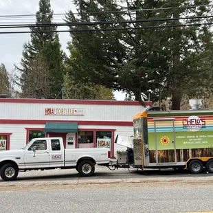 two trucks parked in front of a restaurant