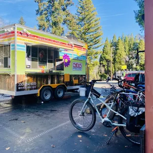 a bike parked in front of a food truck