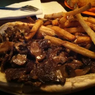 a beef sandwich with fries