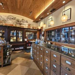 a woman behind the counter in a pharmacy