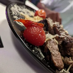 a plate of meat and vegetables on a table