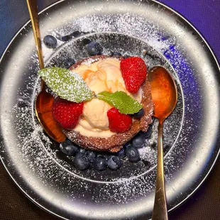 a plate of food with ice cream and berries