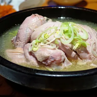 a bowl of soup with meat and vegetables