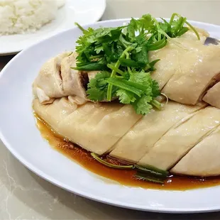 a plate of chicken with rice and sauce