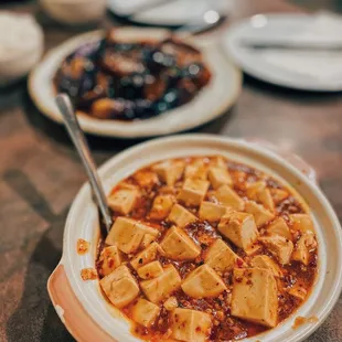 a bowl of stew and a plate of rice