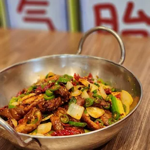 a stir fry dish with meat and vegetables