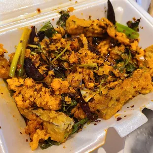 tofu and vegetables in a styrofoam container