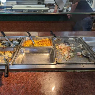 Empty buffet dishes, or old food over cooked by a heated tray.