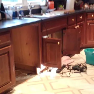 The old dishwasher was removed by Shane using rags for leaks and Teflon strips on the floor