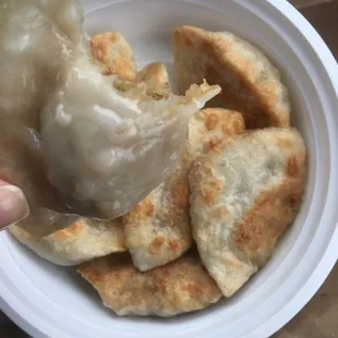 a dumpling being held by a person