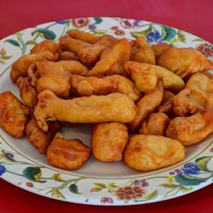 Sweet sour chicken, dip these into a pink sweet sour sauce.