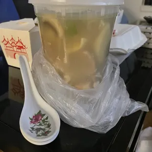 a bowl of soup and a spoon on a table