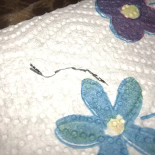 a close up of a towel with flowers on it