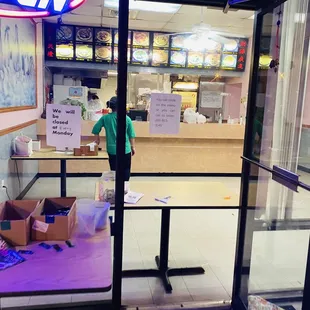 a man standing in the doorway of a restaurant