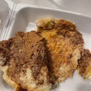 a close up of a meal in a styrofoam container