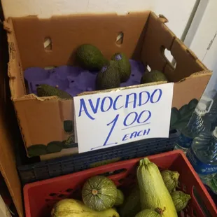 a box of zucchini and avocados