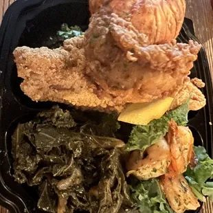 Seafood trio: Fried Lobster Tail, cornmeal crusted catfish, sautéed shrimp, and collard greens.