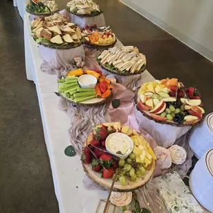 Sandwich spread with sides of fruits and veggies.