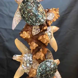 Embellished carving with abalone shells and other local Colorado stone finds.