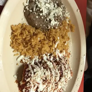 Beans, rice, and chicken enchilada