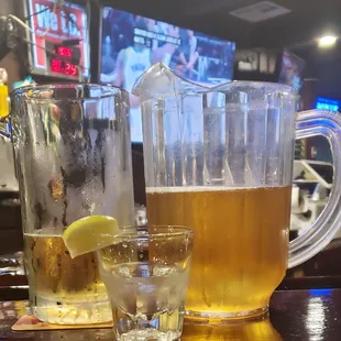 a pitcher of beer and two glasses