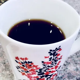 Black coffee in a Cherry  mug.