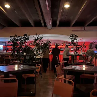 the interior of a restaurant with tables and chairs