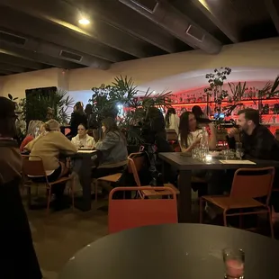 people sitting at tables in a restaurant