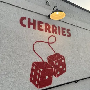 two red dice on a white wall