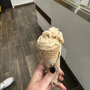 Half scoop caramel apple on a sugar cone