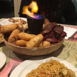 a bowl of food with a flame in it