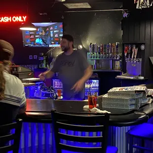 Bartender keeping the drinks coming and the house in good spirits.