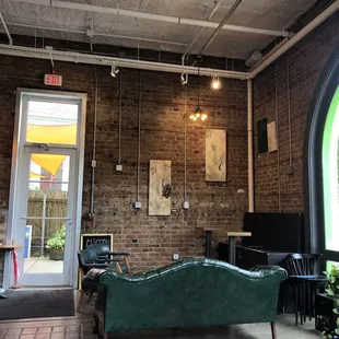 a green couch in a coffee shop