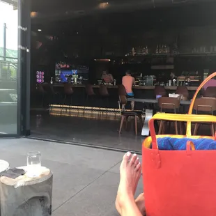 a person sitting on a couch with a red bag