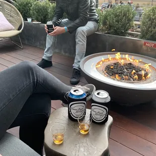 a man sitting in front of a fire pit