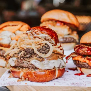 a variety of burgers on a cutting board