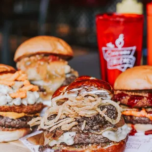 a variety of burgers on a cutting board