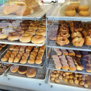 a variety of doughnuts in a display case