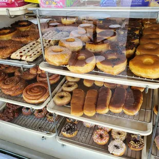 a variety of doughnuts in a display case
