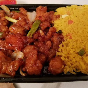 a tray of rice, meat and vegetables