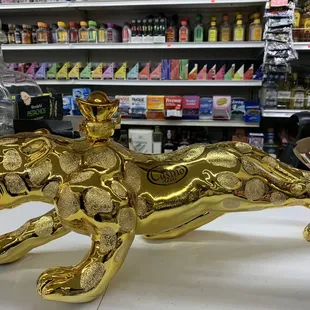 a gold statue of a tiger in a grocery store