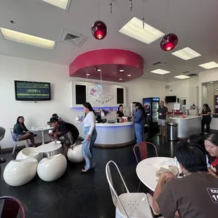 people sitting at tables in a restaurant