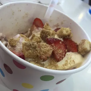 Strawberry Cheesecake yogurt with fresh strawberries, cheesecake bits and graham cracker crumbs